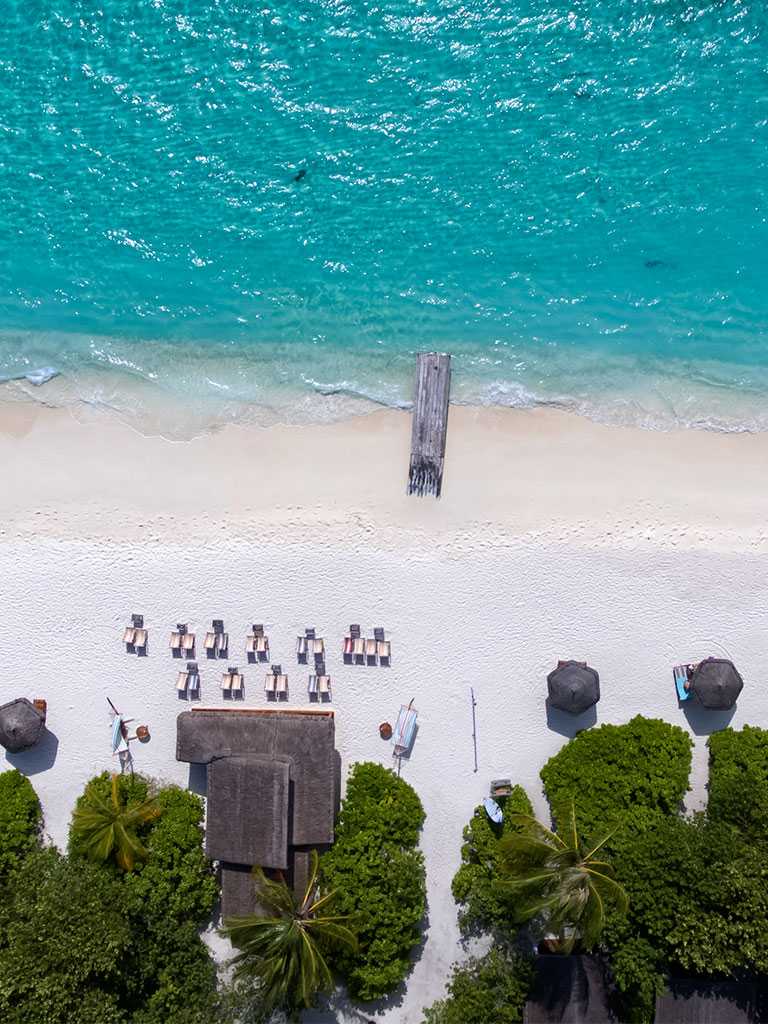 Aerial top view of beach with island at Reethi Resort 