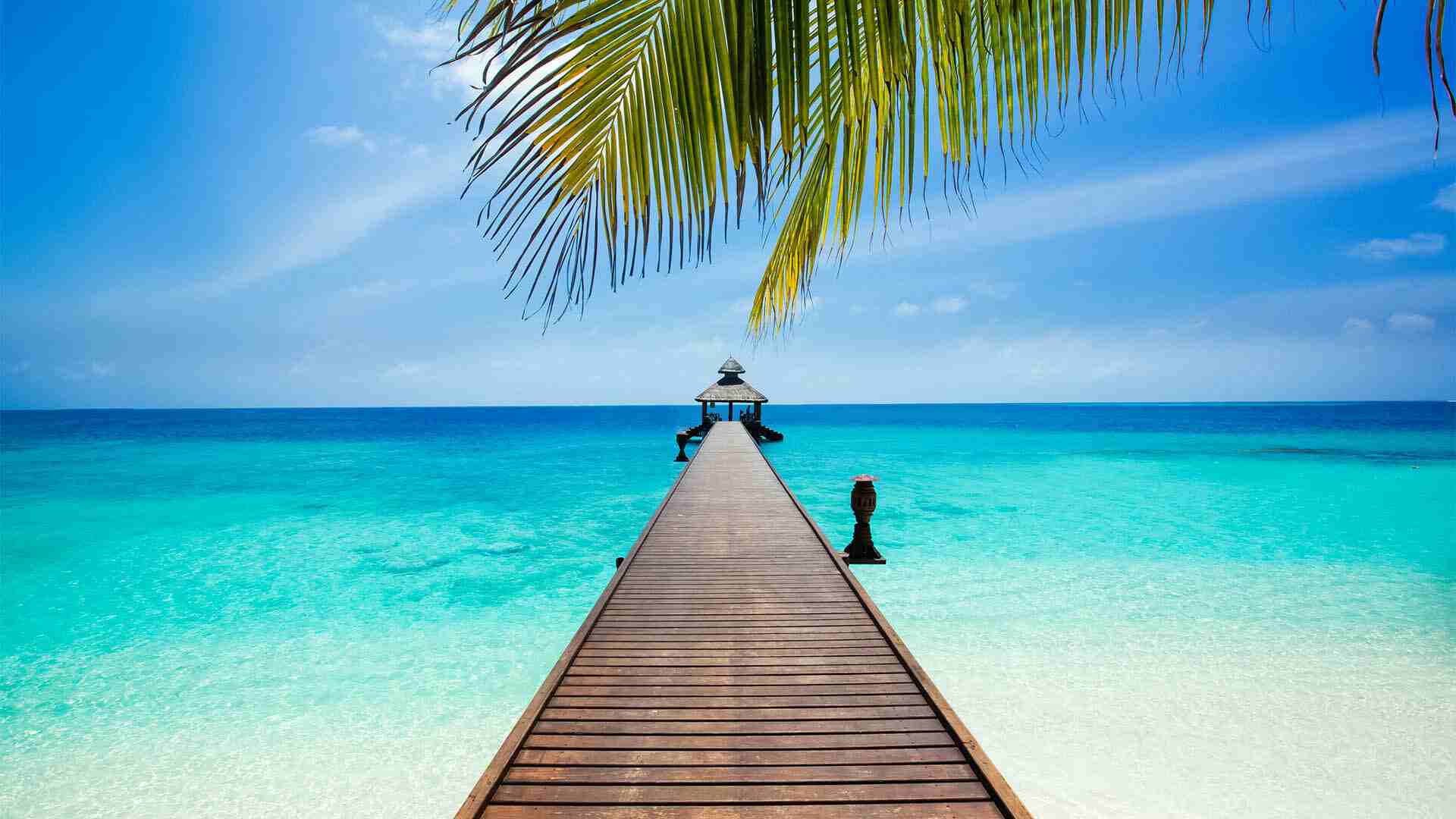 Wooden pier with beach in paradise island at Maldives