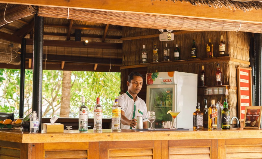 A bar waiter arranges the cocktail at Handhvaru Bar. 