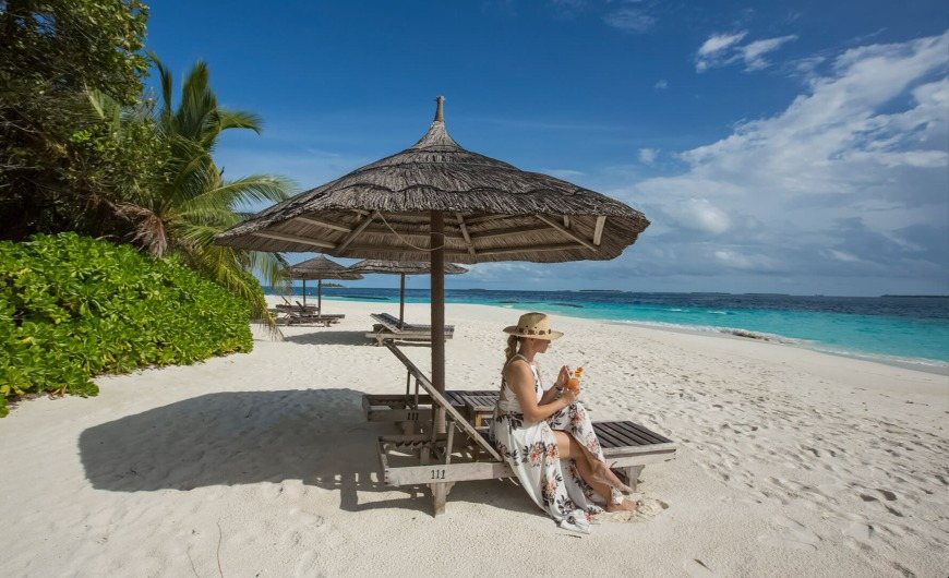 A relaxing in sunbed with fresh Juice at Maldives Beach