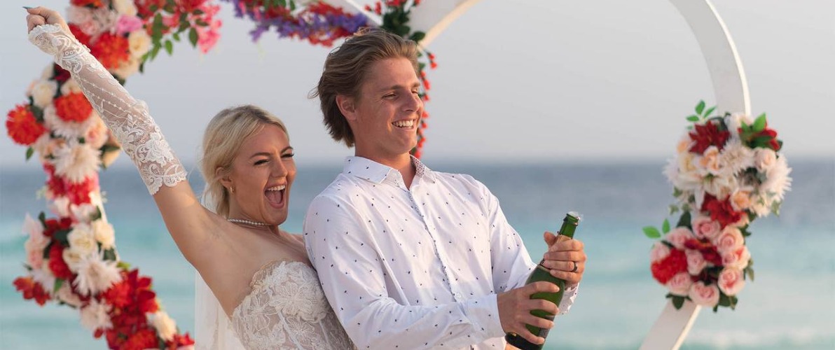 A married couple photo shoots on a Maldives beach.