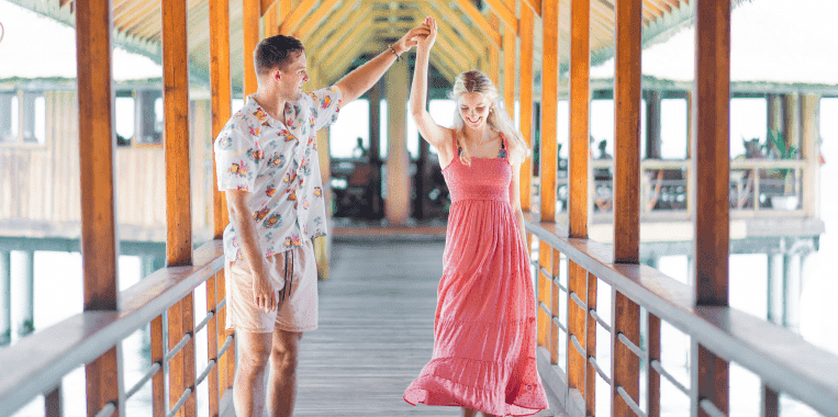 Young couple enjoying on Reethi Beach Resort at Maldives Beach 