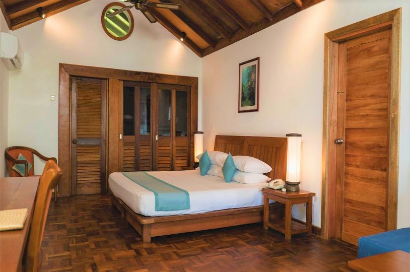 Interior double bed with furniture in a family villa, Maldives