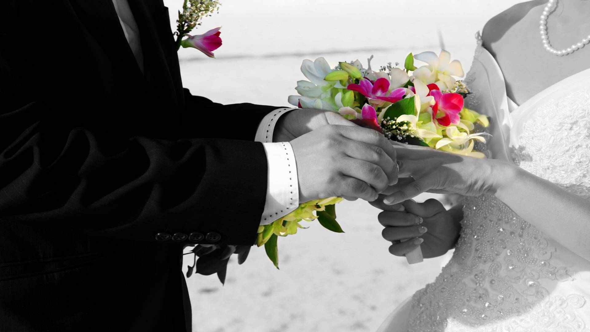 close-up of a hand of a bride with a ring and flowers at the Maldives